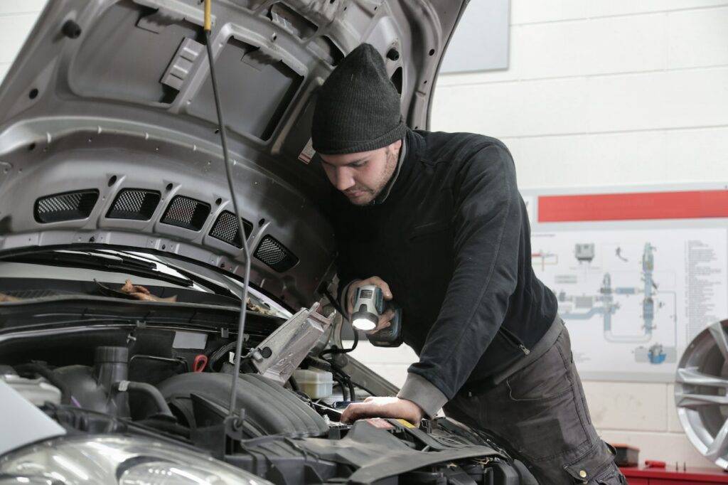 mechanic checking car's engine
